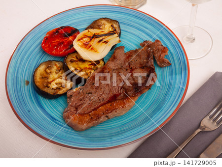 Veal chop and grilled vegetables, healthy dinner Veal chop and grilled vegetables, healthy dinner 141729005
