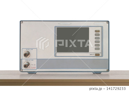 front view old electronic RF (Radio Frequency) signal testing and measuring device resting on a wooden floor, white wall background, object, decor, technology, collection, copy space 141729233