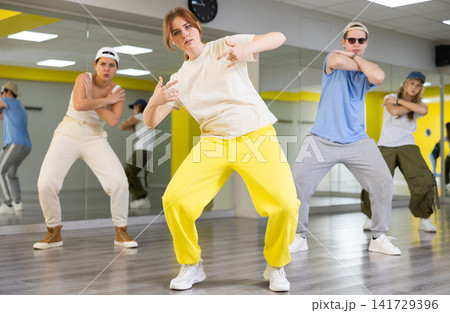 Young girl training breakdance Toprock moves in dance hall Young girl training breakdance Toprock moves in dance hall 141729396
