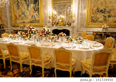 The opulent formal dining room interior with gilded decor and tapestries at Waddesdon Manor The opulent formal dining room interior with gilded decor and tapestries at Waddesdon Manor 141729450