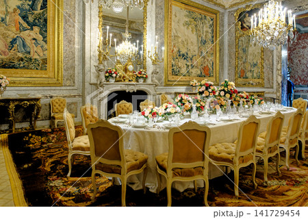 The opulent formal dining room interior with gilded decor and tapestries at Waddesdon Manor The opulent formal dining room interior with gilded decor and tapestries at Waddesdon Manor 141729454