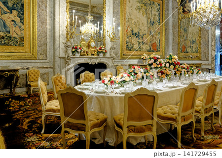 The opulent formal dining room interior with gilded decor and tapestries at Waddesdon Manor The opulent formal dining room interior with gilded decor and tapestries at Waddesdon Manor 141729455