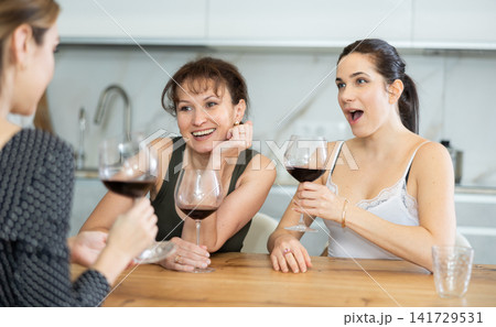 Three women have nice chat-in with wine and conversation 141729531