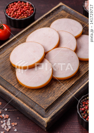 Slices of boiled chicken or pork sausage as an ingredient for home cooking. Sliced boiled sausage Slices of boiled chicken or pork sausage as an ingredient for home cooking. Sliced boiled sausage 141729717
