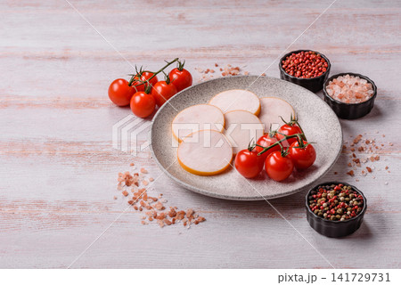 Slices of boiled chicken or pork sausage as an ingredient for home cooking. Sliced boiled sausage Slices of boiled chicken or pork sausage as an ingredient for home cooking. Sliced boiled sausage 141729731
