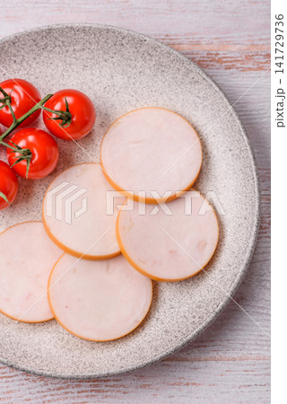 Slices of boiled chicken or pork sausage as an ingredient for home cooking. Sliced boiled sausage Slices of boiled chicken or pork sausage as an ingredient for home cooking. Sliced boiled sausage 141729736