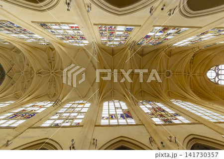 Ornate vaulted ceiling and stained glass in Sezanne church Ornate vaulted ceiling and stained glass in Sezanne church 141730357