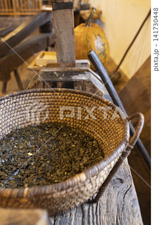 Basket of Styrian pumpkin seeds in traditional mill Basket of Styrian pumpkin seeds in traditional mill 141730448