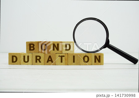 BOND DURATION alphabet letters with magnifying glass on wooden background BOND DURATION alphabet letters with magnifying glass on wooden background 141730998