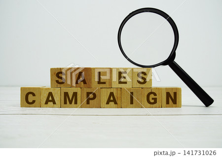 SALES CAMPAIGN alphabet letters with magnifying glass on wooden background SALES CAMPAIGN alphabet letters with magnifying glass on wooden background 141731026