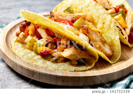 Mexican chicken tacos with bell peppers and onions Mexican chicken tacos with bell peppers and onions 141731339