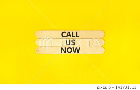 Call us now words symbol. Concept words Call us now on beautiful wooden sticks. Beautiful yellow background. Business support motivational and call us now concept. Copy space. Call us now words symbol. Concept words Call us now on beautiful wooden sticks. Beautiful yellow background. Business support motivational and call us now concept. Copy space. 141731513