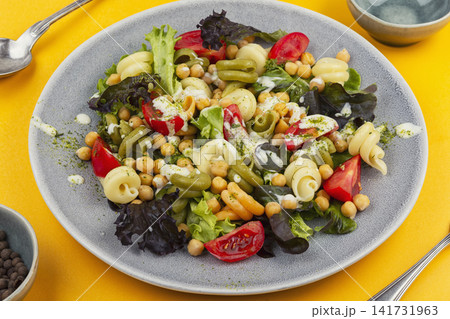 Colorful pasta salad with chickpeas, cherry tomatoes and fresh lettuce Colorful pasta salad with chickpeas, cherry tomatoes and fresh lettuce 141731963
