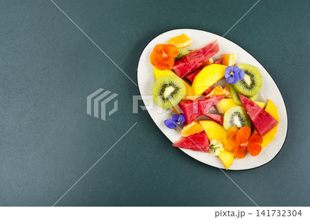 Fresh Summer Fruit Salad with Edible Flowers and Tropical F Fresh Summer Fruit Salad with Edible Flowers and Tropical F 141732304