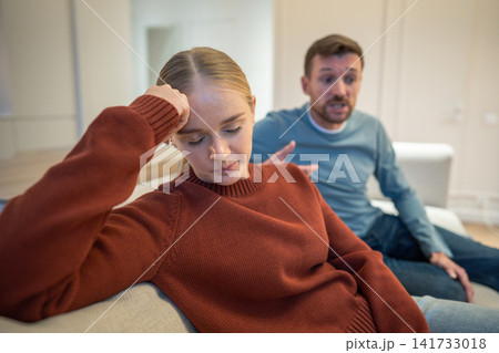 Disappointed apathetic wife listening to male partner dishonest confessions during family quarrel 141733018