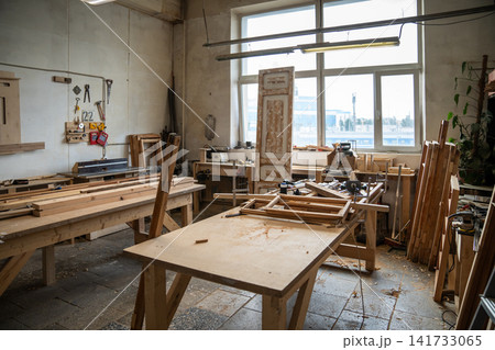 Spacious organized restoration workshop interior featuring worktable, instruments, tools and window. Spacious organized restoration workshop interior featuring worktable, instruments, tools and window. 141733065