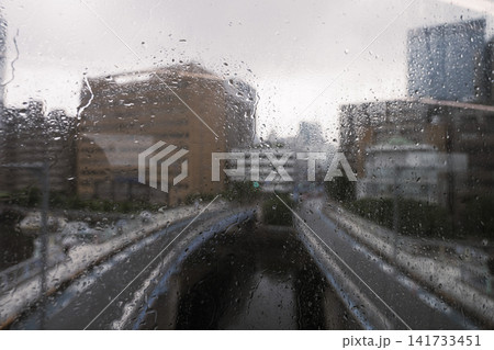 Rainy City Street Through Wet Window Rainy City Street Through Wet Window 141733451