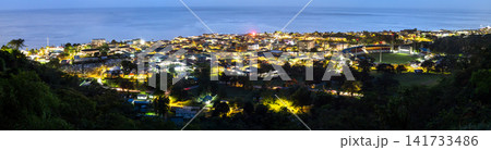 Panoramic view of Roseau city illuminated at night with Windsor Park stadium and the Caribbean Sea from Morne Bruce, Dominica. Panoramic view of Roseau city illuminated at night with Windsor Park stadium and the Caribbean Sea from Morne Bruce, Dominica. 141733486