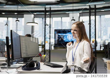 Happy female engineer dancing on office desk chair, pleased after managing to streamline workflows with AI. Cheerful intern celebrating successfully implementing neural networks Happy female engineer dancing on office desk chair, pleased after managing to streamline workflows with AI. Cheerful intern celebrating successfully implementing neural networks 141733539