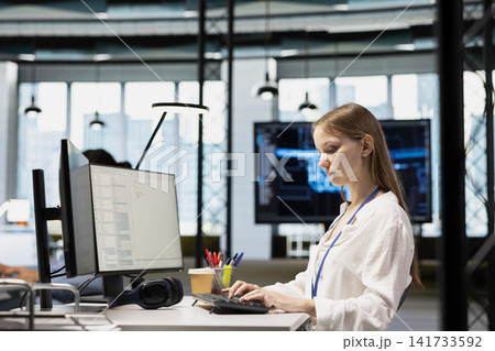 Female engineer developing applications using PC, integrating AI in office systems. Worker doing internship in tech startup debugging applications using artificial intelligence 141733592