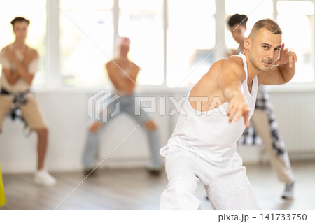 Teenagers girls and boy dancing hip hop in dancing class Teenagers girls and boy dancing hip hop in dancing class 141733750