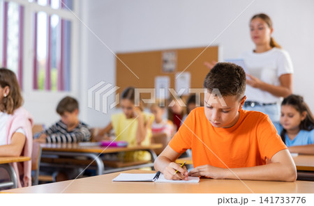 Young boy learning in school 141733776