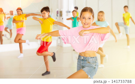 Group of children are learning dance moves in modern studio 141733788