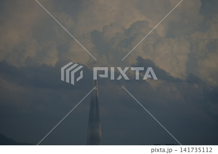 Urban apartment complex under a blue sky and fluffy white clouds 141735112