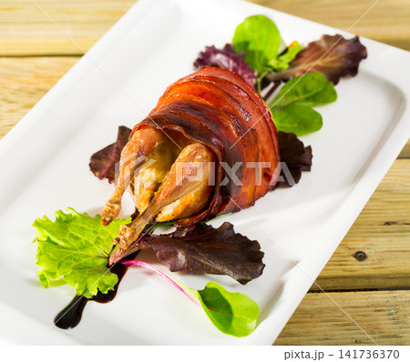 Baked in bacon quail with balsamic sauce is tasty dish Baked in bacon quail with balsamic sauce is tasty dish 141736370