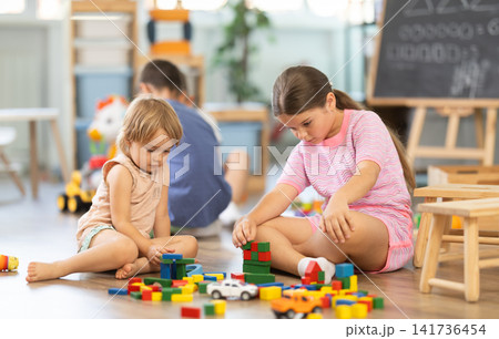 Happy children sitting on floor and spending playing time at classes for kids Happy children sitting on floor and spending playing time at classes for kids 141736454