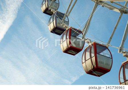 Gondolas rise high above the ground, offering scenic views. Adventure and exploration concept Gondolas rise high above the ground, offering scenic views. Adventure and exploration concept 141736961