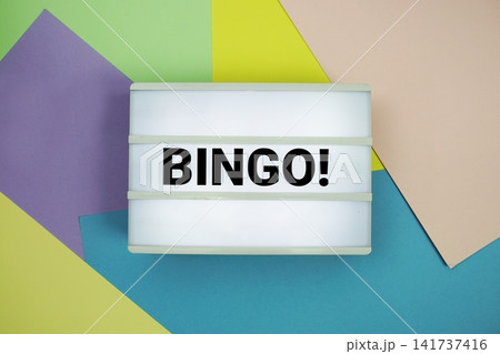 Bingo! text in lightbox flat lay on colorful pastel background Bingo! text in lightbox flat lay on colorful pastel background 141737416