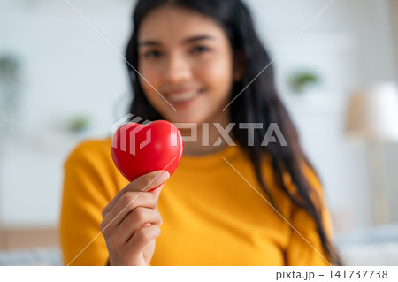 Close-up hand of asian woman holding red heart Close-up hand of asian woman holding red heart 141737738