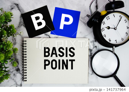 BP Basis Point text written on notepad with alarm clock and magnifying glass on marble background BP Basis Point text written on notepad with alarm clock and magnifying glass on marble background 141737964