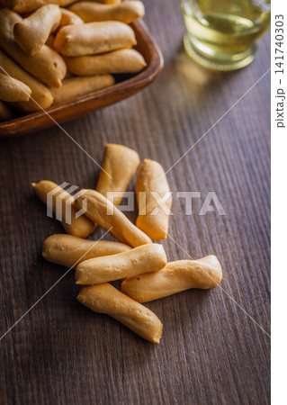 Crispy Breadsticks on Wooden Table With Bowl and Olive Oil for Snack or Appetizer 141740303