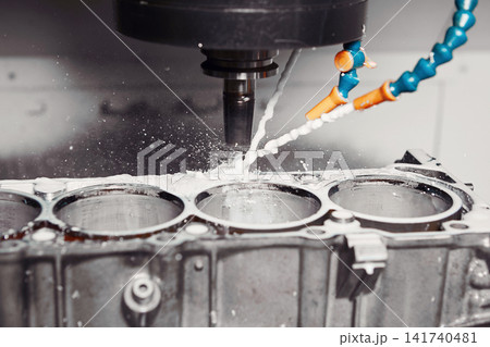 CNC milling machine grinds holes in car engine with coolant. Process of setting up engine cylinder blocks on a numerically controlled machine. CNC milling machine grinds holes in car engine with coolant. Process of setting up engine cylinder blocks on a numerically controlled machine. 141740481