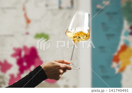Close-Up of Wine Tasting Experience With Swirling Glass Against Map Background Close-Up of Wine Tasting Experience With Swirling Glass Against Map Background 141740491