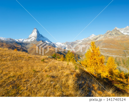 Matterhorn mountain peak rising above a autumn forest in Zermatt, Switzerland Matterhorn mountain peak rising above a autumn forest in Zermatt, Switzerland 141740524