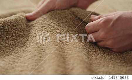 closeup shot of man touching green cotton terry towel closeup shot of man touching green cotton terry towel 141740688