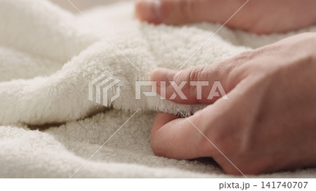 closeup shot of man touching white cotton terry towel closeup shot of man touching white cotton terry towel 141740707