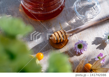 Glass Honey Jar with a Bee Lid and Dipper Detail Glass Honey Jar with a Bee Lid and Dipper Detail 141742086