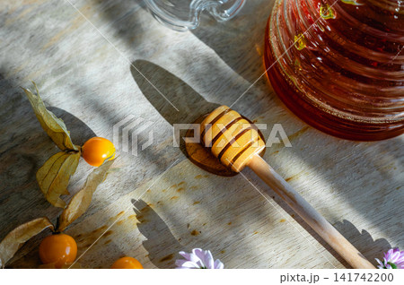 Honey Dipper Beside a Jar with Flowers Detail Honey Dipper Beside a Jar with Flowers Detail 141742200