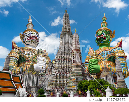 Colorful giant guardian statues with iconic temples of dawn or Wat Arun in Bangkok, Thailand. 141742471