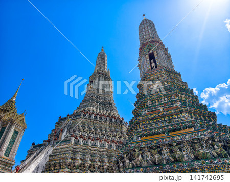 Wat Arun, the Temple of Dawn, under a bright blue sky in Bangkok, Thailand. Wat Arun, the Temple of Dawn, under a bright blue sky in Bangkok, Thailand. 141742695