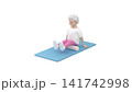 Elderly female performing a foam rolling exercise for the hamstrings on a fitness mat 141742998
