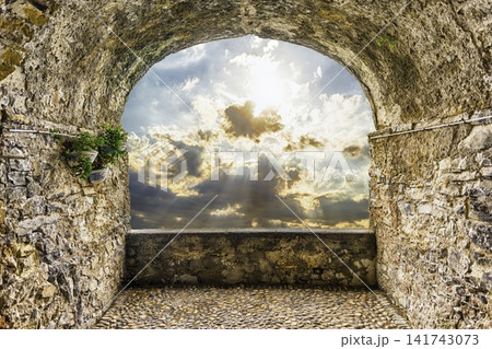 Ancient Stone Archway View to Dramatic Sunset Sky 141743073