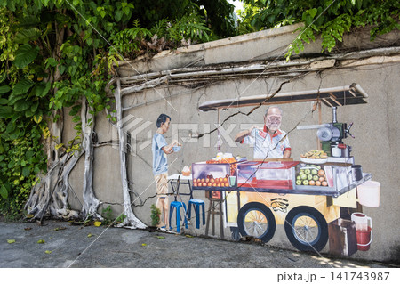 Colorful mural depicting street vendor selling fruits and snacks from cart, with lush greenery surrounding the scene, showcasing vibrant urban art and cultural expression Colorful mural depicting street vendor selling fruits and snacks from cart, with lush greenery surrounding the scene, showcasing vibrant urban art and cultural expression 141743987