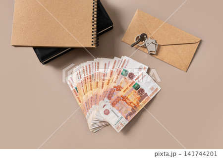 House keys cash and envelope for mortgage payment concept House keys cash and envelope for mortgage payment concept 141744201