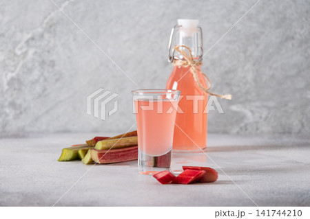 Homemade rhubarb syrup in shot glass 141744210