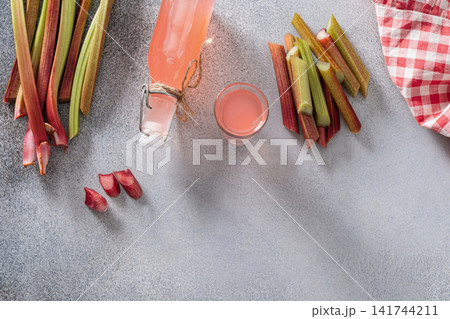 Homemade rhubarb syrup bottle and shot glass 141744211